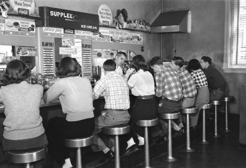 26 View of group of teenage boys and girls sitting together at a soda fountain malt shop counter snack food H Armstrong Roberts Classic Stock Getty Images