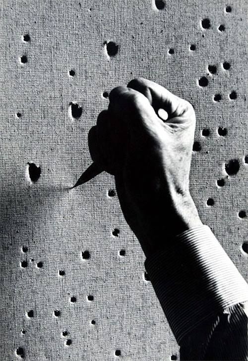 18 Textile texture Lucio Fontana working on one of his artworks DR