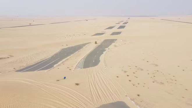 24 Deserted, sand-covered road, Dubai, rights reserved