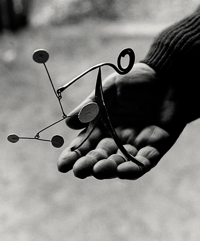 18 Calder holding one of his miniature mobile sculptures Saché France 1963 Ugo Mulas
